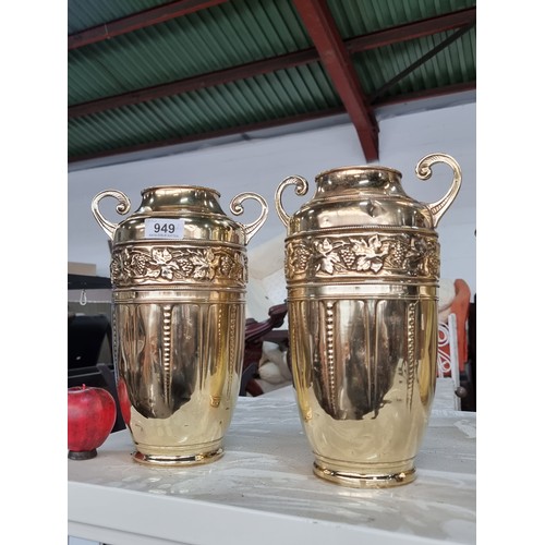 949 - Two vintage brass vases in the form of urns featuring a grape vine motif. Professionally cleaned and... 