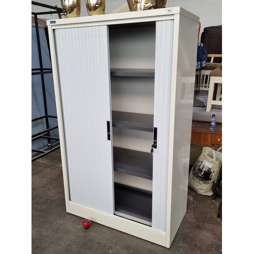 951 - An office cabinet from Silverline with tambour doors and four three shelves. Key included. H166cm x ... 