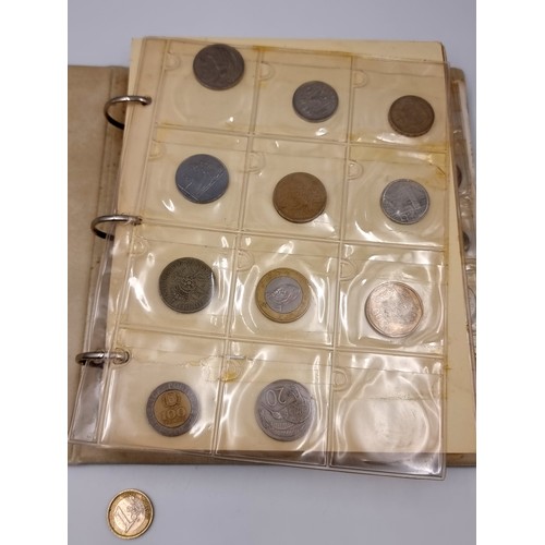 876 - A world coin album containing over 200 antique and vintage coins from all over the world, with many ... 