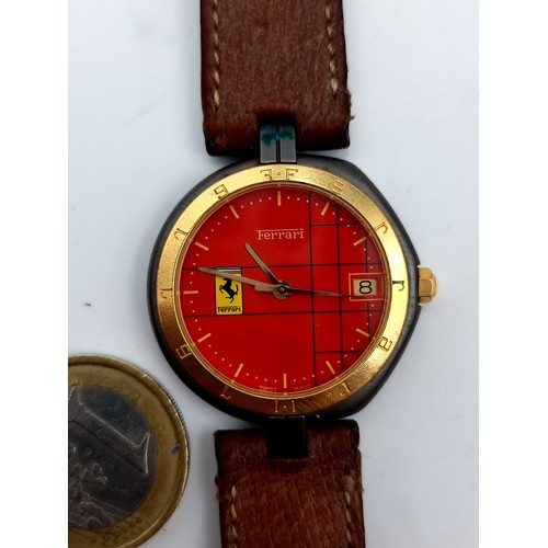 954 - Star Lot : A official Ferrari Formula 1 wrist watch by Cartier set with leather strap and presented ... 