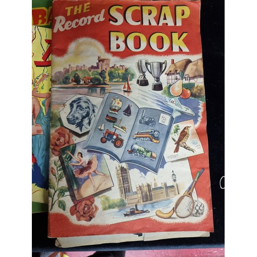 157 - Three vintage items including two scrapbooks featuring various advertisements and colourful illustra... 