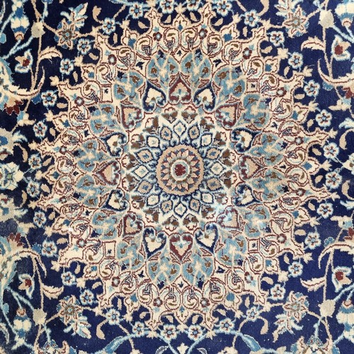 947 - Star Lot: A very large hand knotted wool rug with a highly ornate floral design in shades of cream a... 