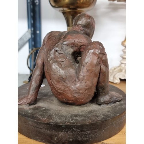 170 - Star lot: A very heavy antique Irish bronze figural sculpture depicting a seated woman held on a rou... 