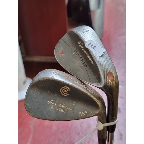 891 - Two wedges including a Cleveland sand wedge and a Taylormade 52 degree wedge.