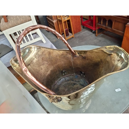 950 - Two fireside items including a vintage stunning  brass coal scuttle, professionally cleaned.  and a ... 