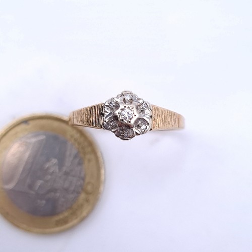 3 - An illusion set diamond ring in 9 carat gold with channel cut shoulders. Ring size Q. Weight 1.8g.