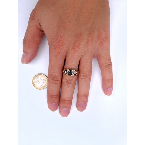 43 - Star Lot : A nice example of a three stone sapphire ring set in 9 carat gold with gem set spacers. S... 