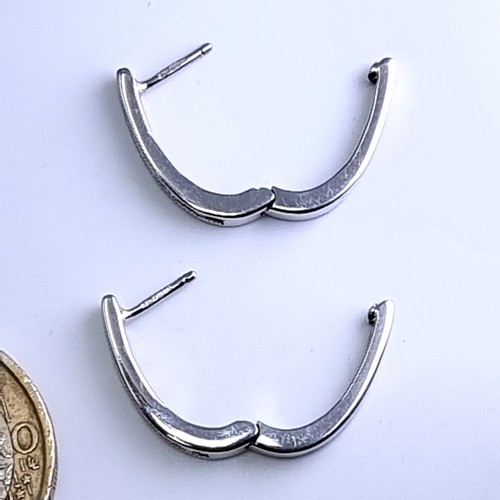 51 - Star Lot : A pair of 9 carat white gold diamond set hoop earrings suitable for pierced ears. Total w... 