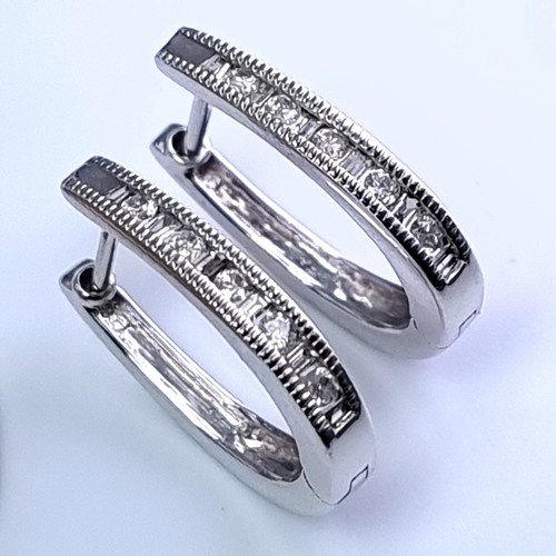 51 - Star Lot : A pair of 9 carat white gold diamond set hoop earrings suitable for pierced ears. Total w... 