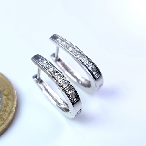 51 - Star Lot : A pair of 9 carat white gold diamond set hoop earrings suitable for pierced ears. Total w... 