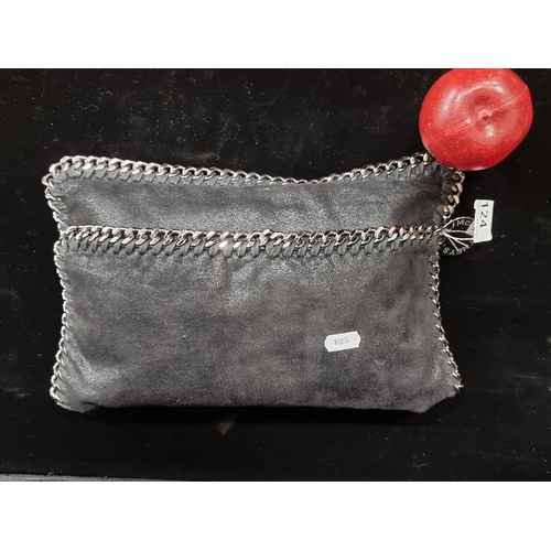 124 - An elegant slouchy clutch  Stella McCartney Falabella design. Edges finished with a thick chain, fea... 