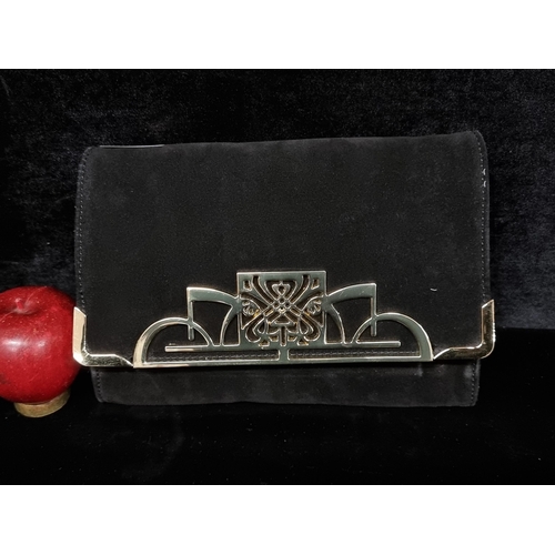 129 - A very elegant Biba clutch bag in a black suede finish with heavy brass hardware. Similar examples r... 