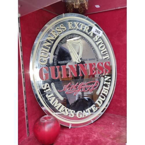 380 - A fine looking circular advertisement mirror for Guinness, featuring wall mounting bracket to back.