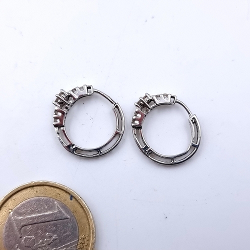 49 - A lovely pair of 10 carat White Gold Diamond cluster hooped earrings. Very pretty pair, with a total... 