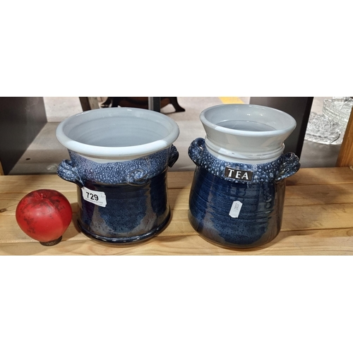 729 - Two  Irish studio art pottery jars including a tea caddy. In a navy and white glaze.