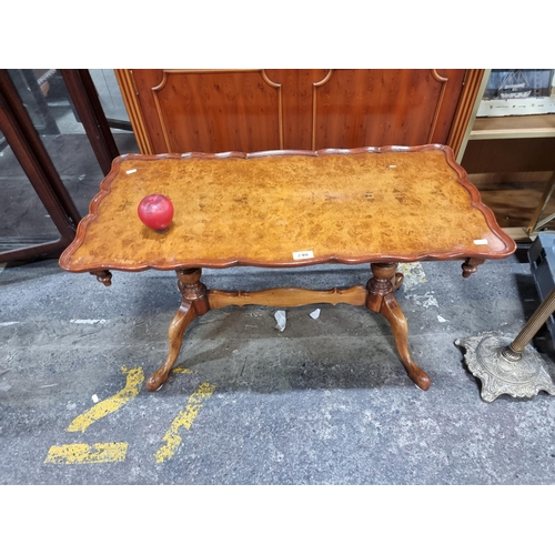 740 - Star Lot : A superb vintage burr walnut pie crust coffee table in The Queen Anne Style. It is a usef... 