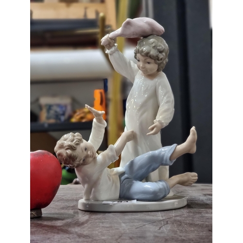 763 - An adorable large Nao porcelain figure of two children playing. In excellent condition.