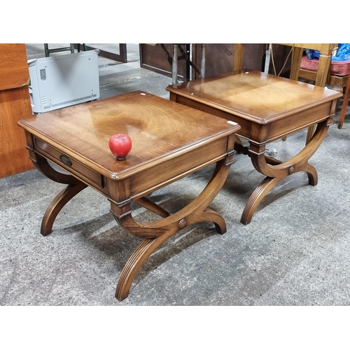 777 - Star Lot : A pair of stylish Regency style side tables with drawers and bow-shaped bases. H52cm x W6... 