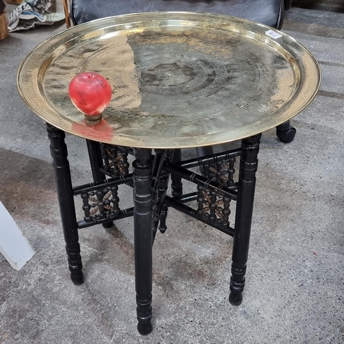 778 - A wonderful early 20th Century Indian brass Benares  tray top occasional table with an ebonised fold... 