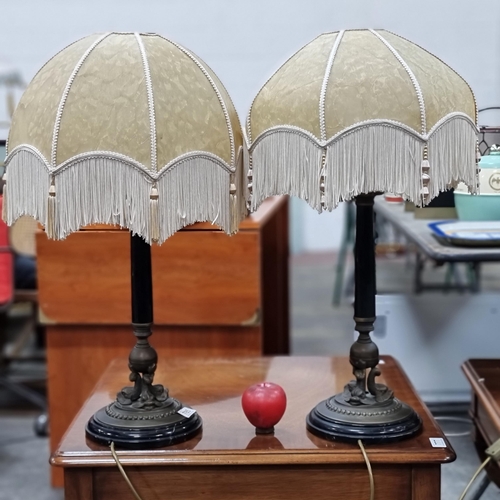 785 - A beautiful pair of table lamps with heavy bases featuring a fish motif. Topped with a hard shell sh... 