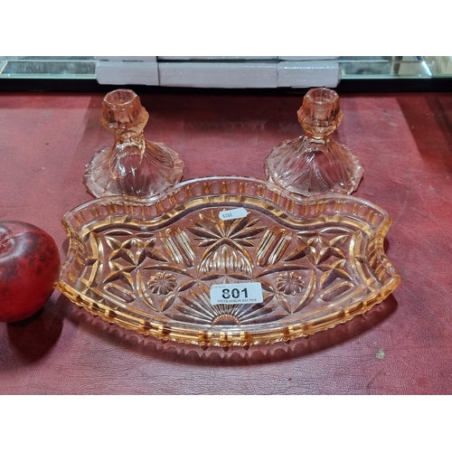 801 - A set of pink glassware including a tray and a pair of candle holders. In very good condition.