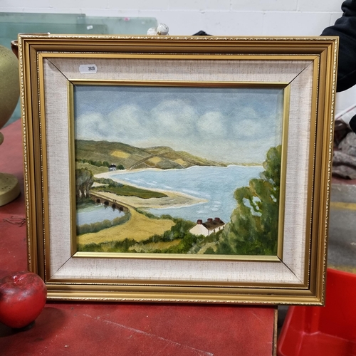 804 - An original oil painting depicting a peaceful landscape featuring a cottage on the coast of a reserv... 