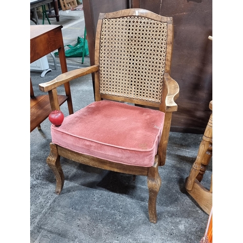 813 - A wonderful Mid Century occasional chair with a wicker backrest, wooden frame with carved armrests, ... 