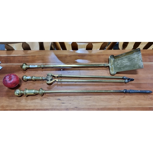 821 - Three antique heavy  brass fire irons, including a shovel, tongs and a poker.