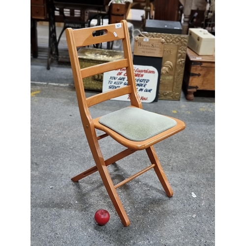 827 - A lovely folding wooden chair with ladder backrest, padded seat and handle to top.