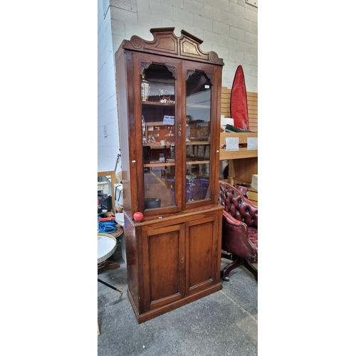 837 - Star Lot : An elegant Victorian display cabinet featuring crown moulding, glass doors to reveal thre... 