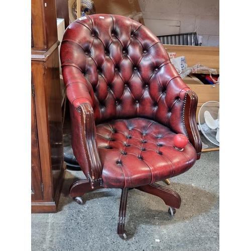 838 - Star Lot : A very handsome vintage Chesterfield captain buttonback swivel chair upholstered in red l... 