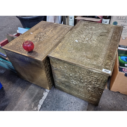 888 - Two vintage brass firewood boxes featuring a tavern and a farming scene. H40cm x W58cm x D35cm.