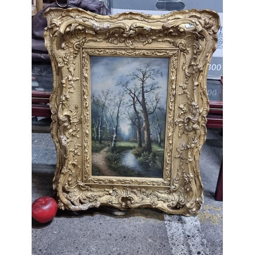 906 - Star lot : An antique original oil on panel painting featuring a forested landscape scene of a meand... 