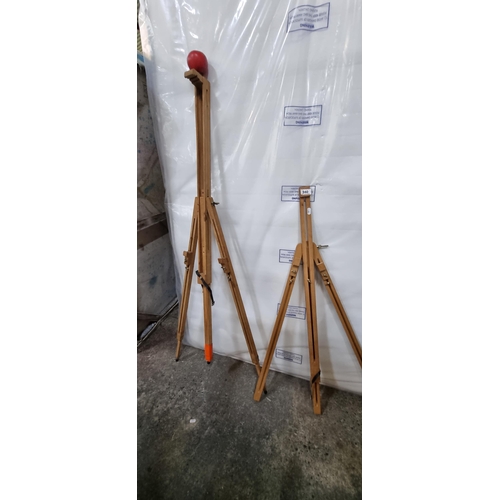 940 - Two wooden artist's easels with adjustable legs and frame, and leather strap to base.