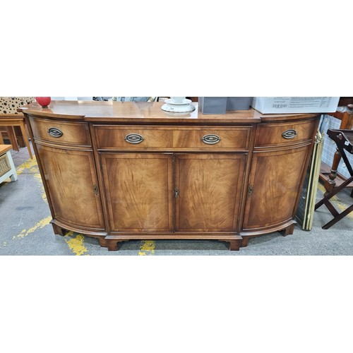 754 - Star Lot : A fabulous vintage English made sideboard featuring a drawer to centre and cabinets to ba... 