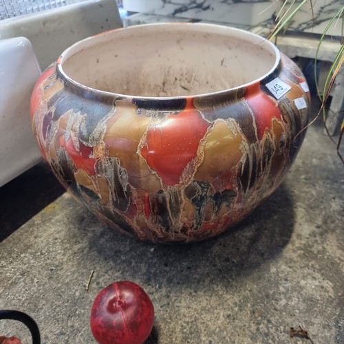 849 - A fabulous very large glazed ceramic planter in vibrant shades of orange and gold.