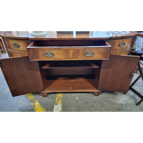 754 - Star Lot : A fabulous vintage English made sideboard featuring a drawer to centre and cabinets to ba... 