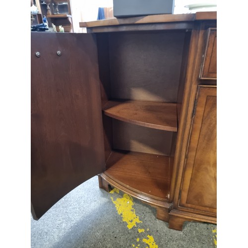 754 - Star Lot : A fabulous vintage English made sideboard featuring a drawer to centre and cabinets to ba... 