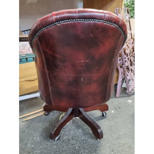 838 - Star Lot : A very handsome vintage Chesterfield captain buttonback swivel chair upholstered in red l... 