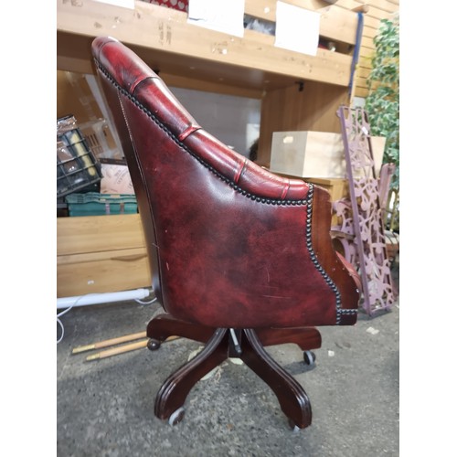 838 - Star Lot : A very handsome vintage Chesterfield captain buttonback swivel chair upholstered in red l... 