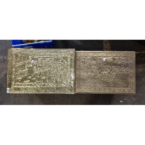 888 - Two vintage brass firewood boxes featuring a tavern and a farming scene. H40cm x W58cm x D35cm.