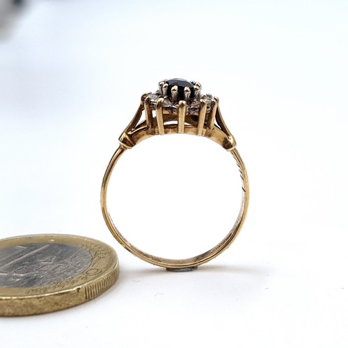 5 - Star Lot : A fine example of a deeply hued Sapphire 9 carat gold ring, featuring a lovely floral clu... 