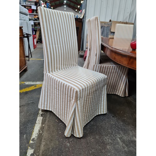 758 - Star Lot : Eight elegant padded dining chairs with wooden legs and cream upholstery. With covers in ... 