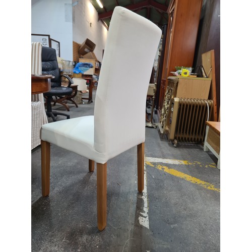 758 - Star Lot : Eight elegant padded dining chairs with wooden legs and cream upholstery. With covers in ... 