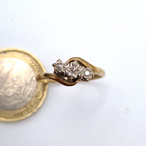 9 - An unusual over lapping three stone Diamond 9 carat gold ring, featuring a pretty twist mount. Ring ... 