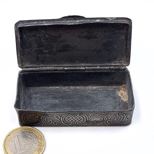 33 - An antique pretty pewter hinged snuff box, set with embossed floral motif and incised detail. Length... 