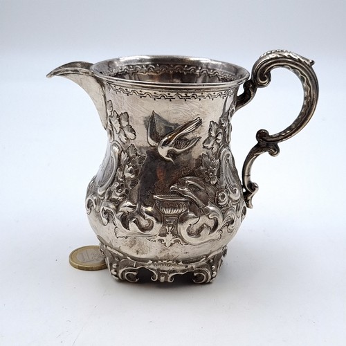 47 - A profusely detailed Victorian Repousse relief sterling silver creamer, featuring beautiful floral a... 