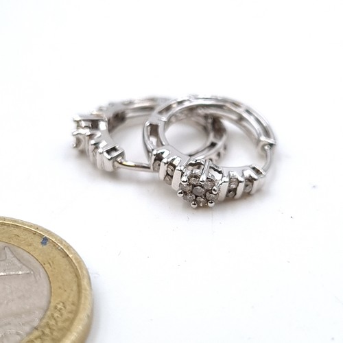 49 - A lovely pair of 10 carat White Gold Diamond cluster hooped earrings. Very pretty pair, with a total... 