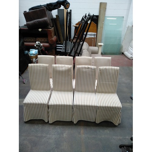 758 - Star Lot : Eight elegant padded dining chairs with wooden legs and cream upholstery. With covers in ... 