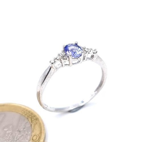 10 - Star Lot : An unusual 9 carat white gold Tanzanite stone ring, set with sparkling White Sapphires du... 